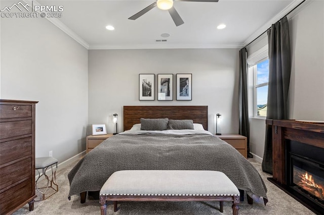 carpeted bedroom featuring ceiling fan and ornamental molding