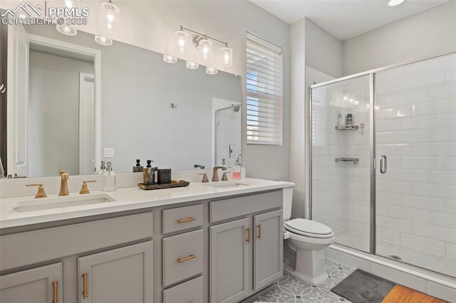 bathroom featuring tile patterned floors, vanity, toilet, and walk in shower