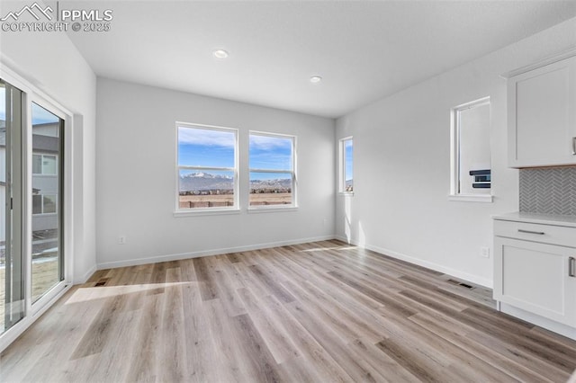 unfurnished dining area with light hardwood / wood-style flooring