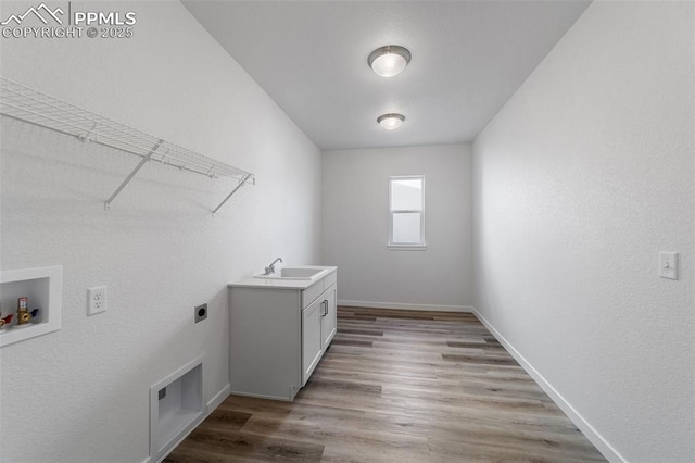 laundry room with cabinets, hookup for a washing machine, light wood-type flooring, hookup for an electric dryer, and sink