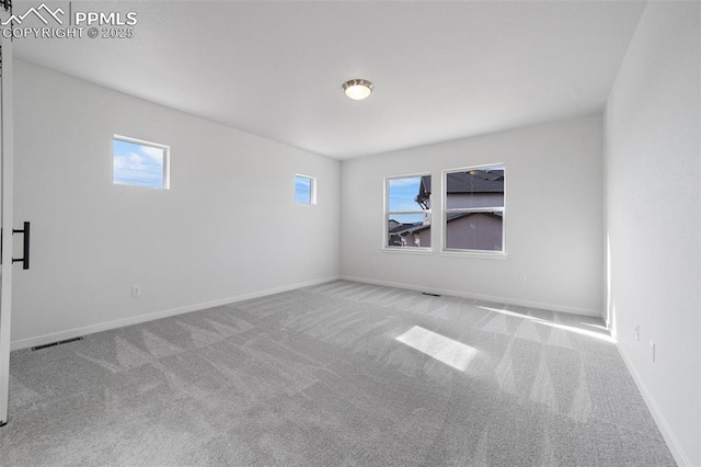 spare room with light colored carpet