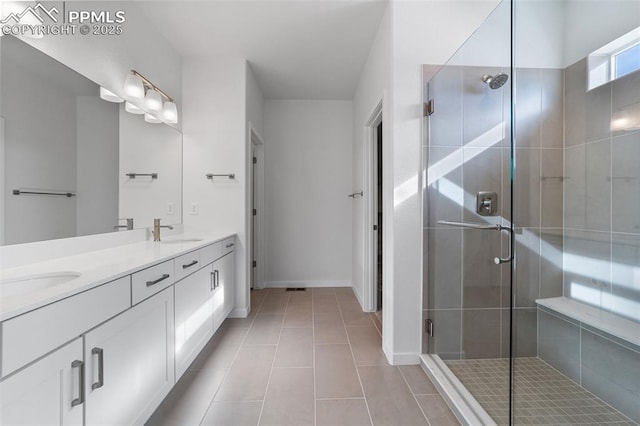 bathroom featuring tile patterned floors, vanity, and a shower with door