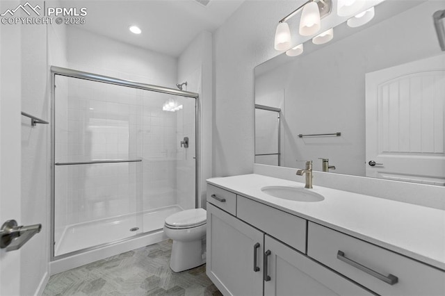 bathroom featuring vanity, toilet, and walk in shower