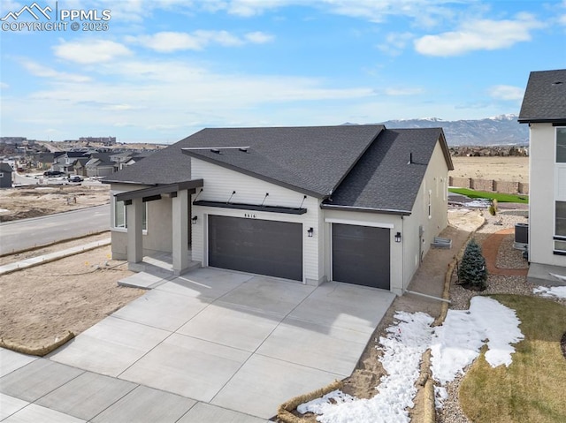 view of side of property featuring a mountain view and a garage