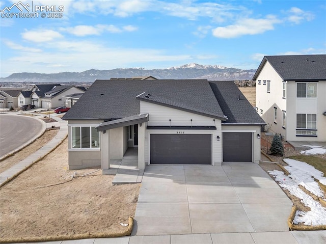 view of front of home with a mountain view and a garage