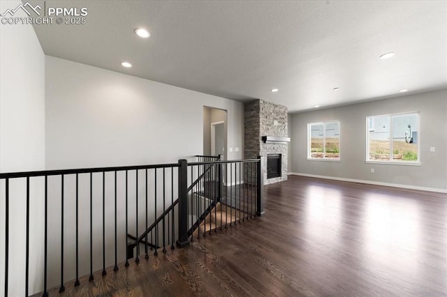 living room with a fireplace and dark wood-type flooring