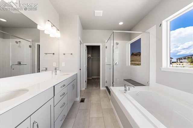 bathroom featuring vanity, separate shower and tub, and plenty of natural light