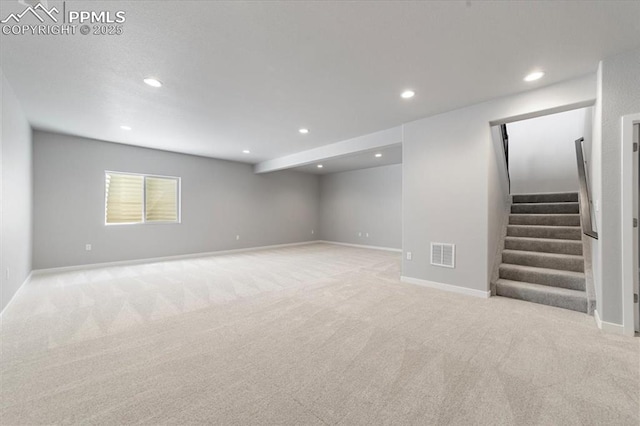 basement featuring light carpet