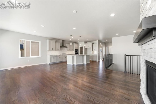 unfurnished living room featuring a fireplace and dark hardwood / wood-style flooring