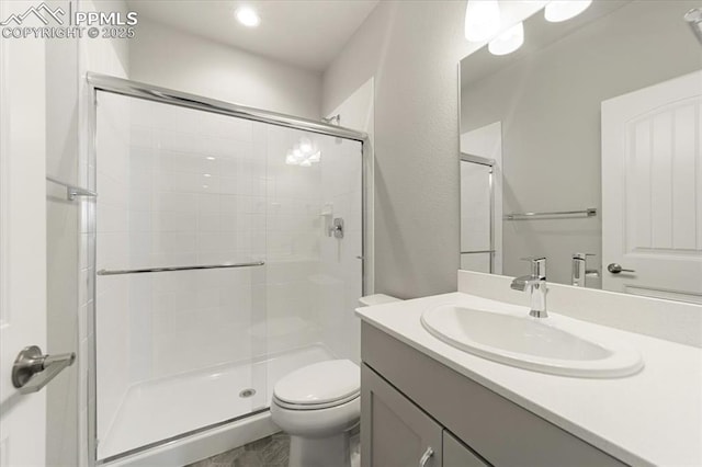 bathroom with vanity, toilet, and walk in shower