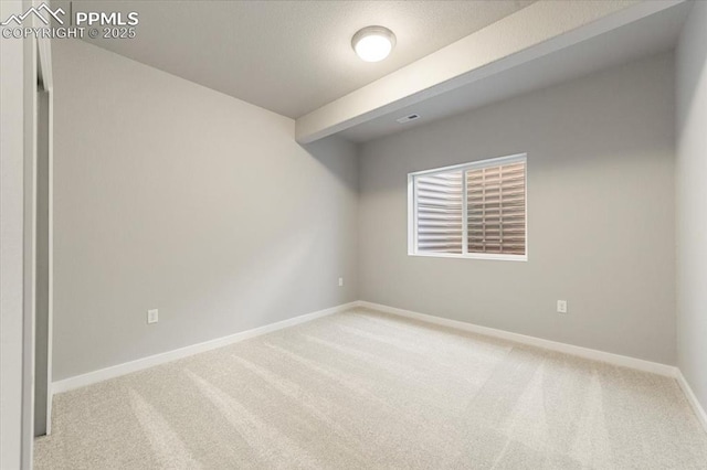 unfurnished room featuring light carpet