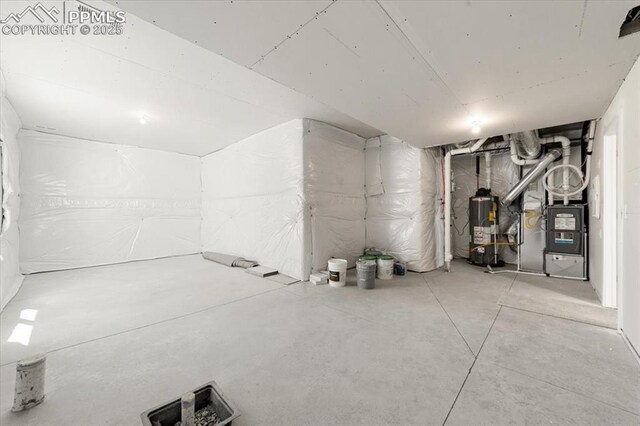 basement with gas water heater and heating unit