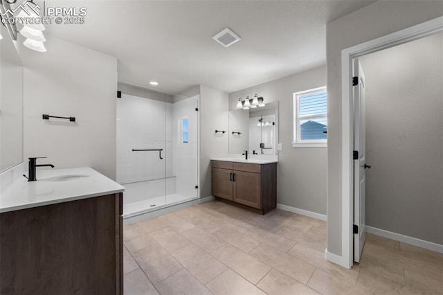 bathroom with tile patterned flooring, vanity, and a shower with door