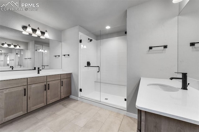 bathroom with vanity and a shower with shower door