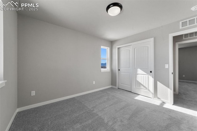 unfurnished bedroom featuring carpet floors and a closet