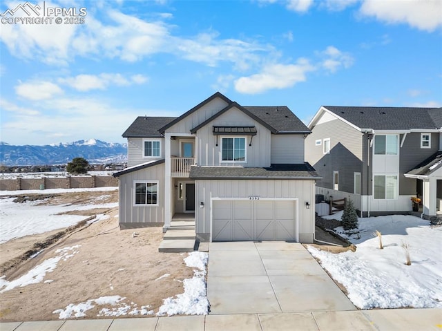 view of front of house featuring a mountain view, a balcony, and a garage