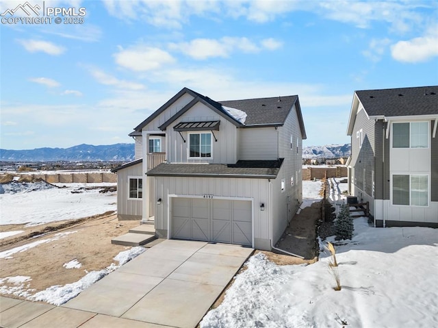 view of front of property with a mountain view and a garage