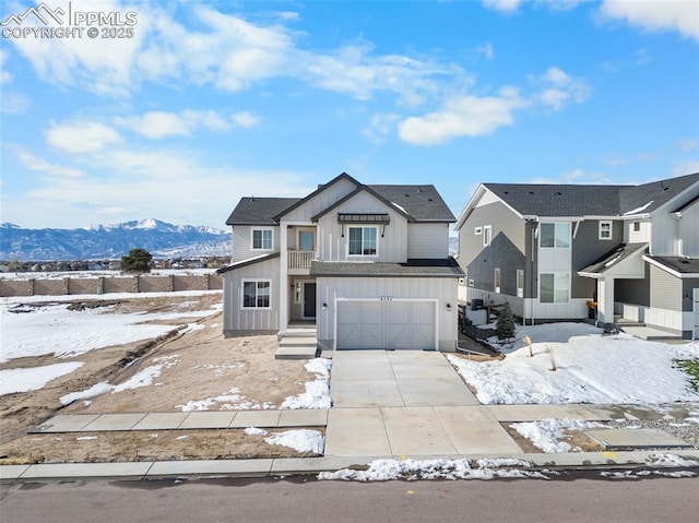 view of front facade with a mountain view and a garage