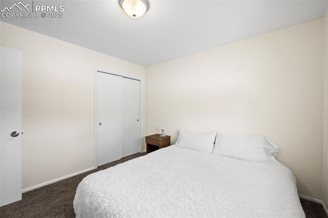 bedroom with a closet and dark colored carpet