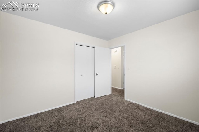 unfurnished bedroom with a closet and carpet floors