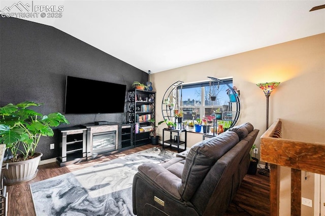 living room featuring vaulted ceiling and wood-type flooring