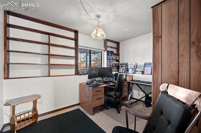 carpeted office featuring a textured ceiling