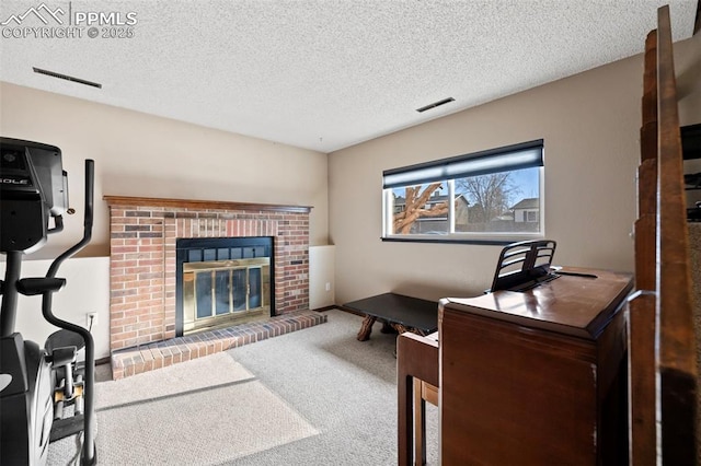 carpeted office with a textured ceiling and a brick fireplace