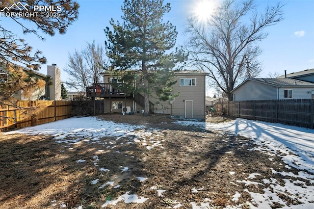 snow covered property featuring a wooden deck