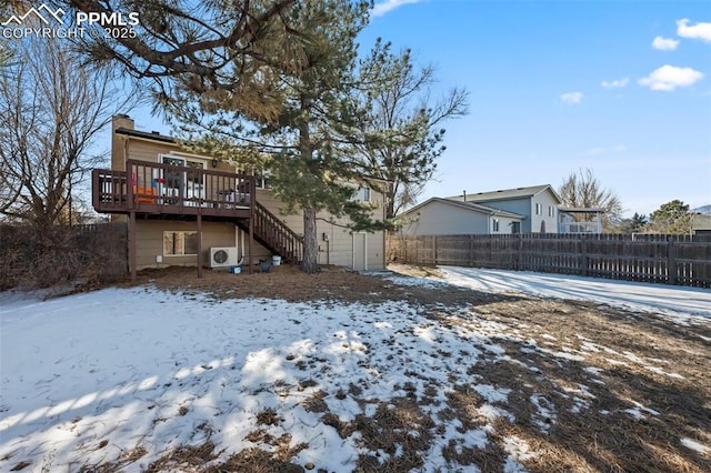 snow covered rear of property featuring a wooden deck