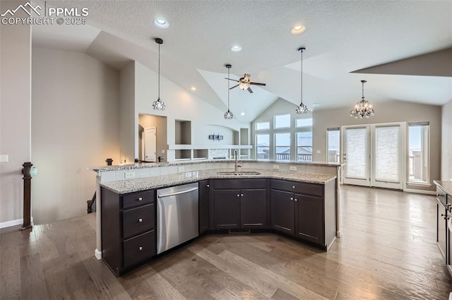 kitchen with hardwood / wood-style floors, a kitchen island with sink, dishwasher, and sink