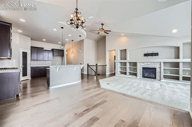 kitchen with pendant lighting, a center island, tasteful backsplash, and a fireplace