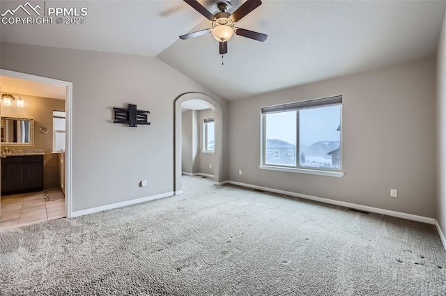 interior space featuring ceiling fan and vaulted ceiling