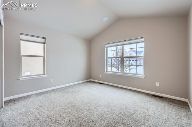 unfurnished room featuring vaulted ceiling and carpet