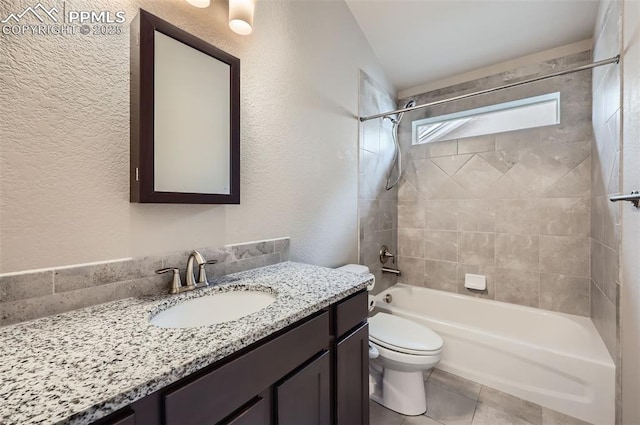 full bathroom featuring toilet, tiled shower / bath combo, and vanity