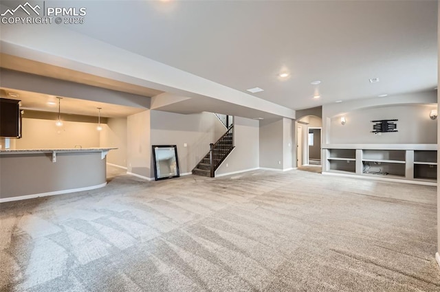 unfurnished living room featuring built in features and light carpet