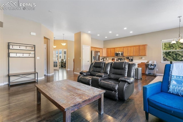 living room with a notable chandelier and dark hardwood / wood-style floors