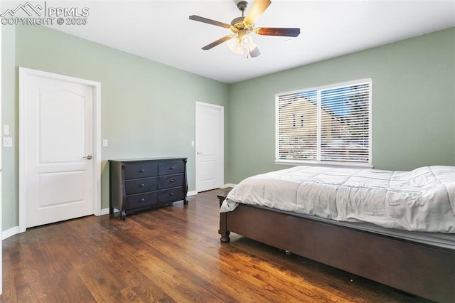 bedroom with ceiling fan and dark hardwood / wood-style floors