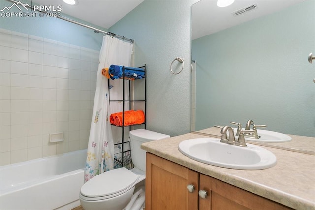 full bathroom featuring vanity, shower / tub combo, and toilet