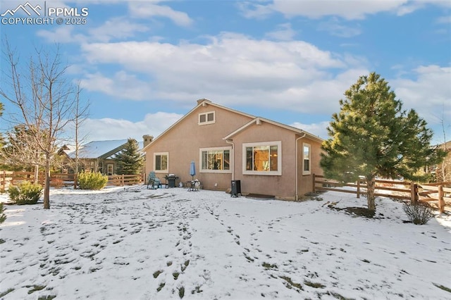 view of snow covered rear of property