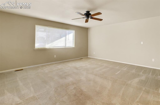 empty room featuring ceiling fan and light colored carpet