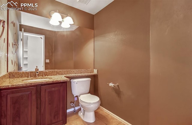 bathroom with tile patterned flooring, vanity, and toilet