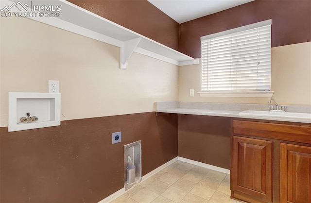 laundry area with hookup for an electric dryer and sink