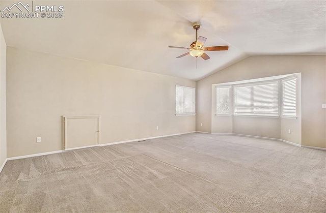 unfurnished room with ceiling fan, light carpet, and vaulted ceiling