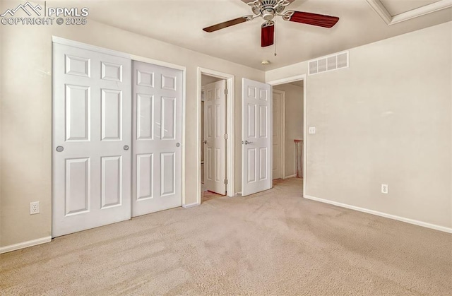 unfurnished bedroom with ceiling fan, a closet, and light carpet