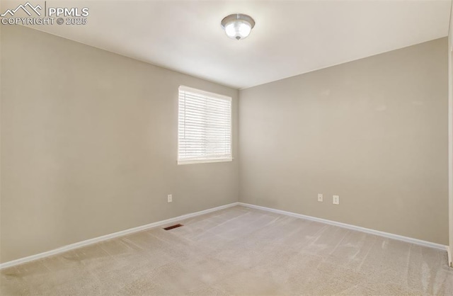 empty room with light colored carpet