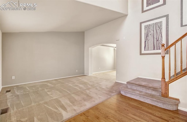 interior space featuring hardwood / wood-style floors and vaulted ceiling