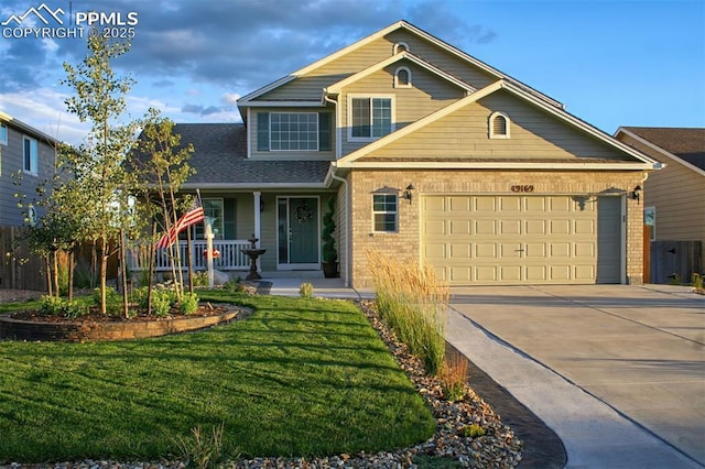 view of front of home with a garage, covered porch, and a front lawn