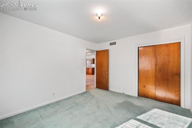 unfurnished bedroom featuring a closet and carpet flooring