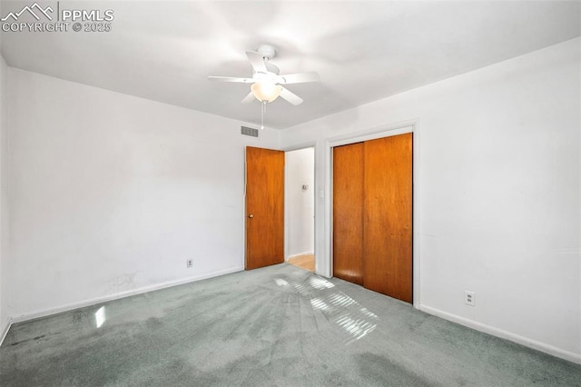 unfurnished bedroom featuring carpet, ceiling fan, and a closet