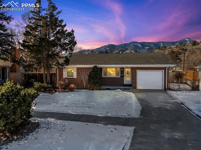 ranch-style home with a mountain view and a garage